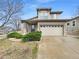 Charming two-story home featuring neutral siding, manicured landscaping, and an attached two-car garage at 10674 Cherrington St, Highlands Ranch, CO 80126