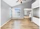 Bright living room features hardwood floors, vaulted ceilings, and stylish shutters for natural light at 10674 Cherrington St, Highlands Ranch, CO 80126