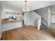 Open-concept living space with hardwood floors, staircase, and a bright kitchen with granite counters at 10674 Cherrington St, Highlands Ranch, CO 80126