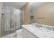 Bathroom with updated tile shower and granite countertop at 4626 Longs Ct, Broomfield, CO 80023