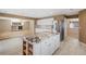 Modern kitchen island with granite countertops, stainless steel refrigerator, and open layout at 4626 Longs Ct, Broomfield, CO 80023