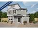 Charming two-story home featuring a covered front porch and neutral siding, nestled in a landscaped yard at 46537 Sunflower Ln, Bennett, CO 80102