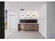 Finished basement wet bar boasts modern lighting, sleek countertops, and stylish wooden cabinetry at 5031 Moss Pl, Golden, CO 80403