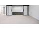Basement view featuring sliding glass barn doors leading to a dark room, carpeted floors, and recessed lighting at 5031 Moss Pl, Golden, CO 80403