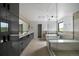 Modern bathroom featuring dual vanity, soaking tub, and glass-enclosed shower at 5031 Moss Pl, Golden, CO 80403
