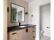 Bathroom vanity with wood cabinets, dark countertop, and modern lighting at 5031 Moss Pl, Golden, CO 80403
