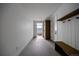 Clean entryway with hooks, bench, and open pantry space at 5031 Moss Pl, Golden, CO 80403