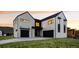 Modern two-story home with sleek exterior and dark garage doors at 5031 Moss Pl, Golden, CO 80403
