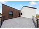 Modern home exterior features a spacious rooftop patio with a sleek railing, brick and stucco at 5031 Moss Pl, Golden, CO 80403