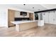 Bright open kitchen features stainless appliances, large island, and sleek modern lighting at 5031 Moss Pl, Golden, CO 80403