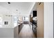 Bright open kitchen features stainless appliances, large island, and sleek modern lighting at 5031 Moss Pl, Golden, CO 80403