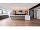 Bright open kitchen features stainless appliances, large island, and sleek modern lighting at 5031 Moss Pl, Golden, CO 80403