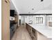 Bright open kitchen features stainless appliances, large island, and sleek modern lighting at 5031 Moss Pl, Golden, CO 80403