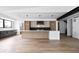 Bright open kitchen features stainless appliances, large island, and sleek modern lighting at 5031 Moss Pl, Golden, CO 80403