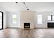 Bright living room with a modern fireplace, hardwood floors, and plenty of natural light at 5031 Moss Pl, Golden, CO 80403
