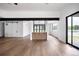 Bright living space with hardwood floors, a wet bar, and large windows for ample natural light at 5031 Moss Pl, Golden, CO 80403
