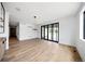 Bright living space features hardwood floors, a wet bar, and a sliding glass door for natural light at 5031 Moss Pl, Golden, CO 80403