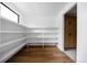Walk-in pantry with wooden floors and extensive white shelving offers plenty of storage space at 5031 Moss Pl, Golden, CO 80403