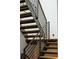 Modern staircase with wood treads and metal railings offers a stylish and functional design element at 5031 Moss Pl, Golden, CO 80403