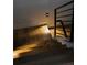 Close-up of a modern staircase with wood treads and metal railings with ambient stair lighting at 5031 Moss Pl, Golden, CO 80403