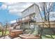 Back exterior with deck, hot tub, patio, and landscaped yard at 11035 W Grand Pl, Littleton, CO 80127