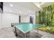 Finished basement featuring a ping pong table, wood-look flooring, and a forest-themed accent wall at 11035 W Grand Pl, Littleton, CO 80127