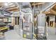 Basement utility area with furnace, water heater, and storage shelving at 11035 W Grand Pl, Littleton, CO 80127