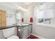 Updated bathroom features modern vanity, mirror, and ample lighting at 11035 W Grand Pl, Littleton, CO 80127
