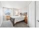 Cozy bedroom with carpet floors, a window with sheer curtains, and wood furniture at 11035 W Grand Pl, Littleton, CO 80127