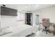 Cozy bedroom features a bed, workspace, corner shelving, and a window with natural light at 11035 W Grand Pl, Littleton, CO 80127