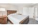 Cozy bedroom featuring a queen bed, carpet, wood furnishings, and a sliding door closet at 11035 W Grand Pl, Littleton, CO 80127
