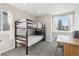 Bright bedroom featuring bunk beds, a desk and chair, and lots of natural light from the windows at 11035 W Grand Pl, Littleton, CO 80127