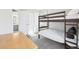 Bedroom with a bunk bed, desk and chair, large window, and an open view to an attached bathroom at 11035 W Grand Pl, Littleton, CO 80127
