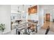 Stylish dining area with modern lighting fixtures and a glass-top table set for a meal at 11035 W Grand Pl, Littleton, CO 80127