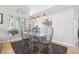 Chic dining room with decorative lighting, carpet, and many windows providing natural light at 11035 W Grand Pl, Littleton, CO 80127