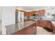 Modern kitchen with stainless steel appliances, center island, and ample storage space at 11035 W Grand Pl, Littleton, CO 80127