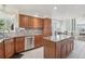 Bright kitchen boasts granite countertops, stainless steel appliances, mosaic backsplash, and tile floors at 11035 W Grand Pl, Littleton, CO 80127