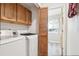 Convenient laundry room with washer, dryer, cabinets, and space for storage at 11035 W Grand Pl, Littleton, CO 80127