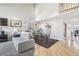 Open-concept living room with hardwood floors, high ceilings, and plenty of natural light at 11035 W Grand Pl, Littleton, CO 80127