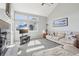 Inviting living room featuring brick fireplace, many windows, vaulted ceilings, and comfortable seating at 11035 W Grand Pl, Littleton, CO 80127