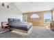 Spacious main bedroom with wood paneling, unique windows, and neutral carpet at 11035 W Grand Pl, Littleton, CO 80127
