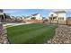 Backyard landscape with artificial turf and wooden fence at 1171 E Hopkins Dr, Elizabeth, CO 80107