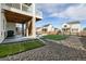 Backyard patio featuring nice stone work with artificial turf and landscaping at 1171 E Hopkins Dr, Elizabeth, CO 80107