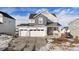 Two-story house with gray and white siding, three-car garage, and a landscaped yard at 1171 E Hopkins Dr, Elizabeth, CO 80107