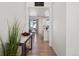 Hallway with hardwood floors offering views into the kitchen and living areas at 1171 E Hopkins Dr, Elizabeth, CO 80107