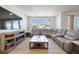 Living room featuring a sectional sofa, built-in fireplace, and large windows at 1171 E Hopkins Dr, Elizabeth, CO 80107