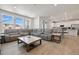 Spacious living room with large windows, a sectional sofa, and a marble-top coffee table at 1171 E Hopkins Dr, Elizabeth, CO 80107