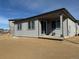 Backyard view of home with neutral siding and sliding glass door at 8945 Rifle St, Commerce City, CO 80022