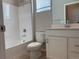 Bright bathroom showcasing a white vanity, toilet, and a bathtub with white tiled walls at 8945 Rifle St, Commerce City, CO 80022