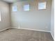 This bedroom features neutral walls, plush carpet and an abundance of natural light from three windows at 8945 Rifle St, Commerce City, CO 80022